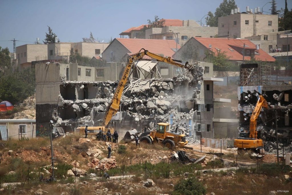 Israeli forces use machinery to demolish buildings in ramallah west bank to build new settlements July 2015