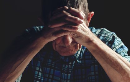 bigstock depressed senior covers his fa 346521910