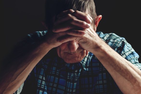bigstock depressed senior covers his fa 346521910
